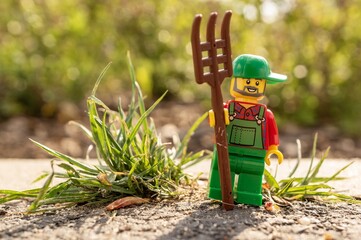 Naklejka premium Lego farmer with pitchfork.