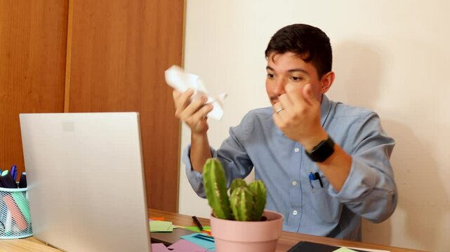 Very angry and furious businessman talking on video call conference using laptop at office, concept of anger and frustration at work
