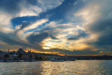 Naklejka premium view from a pleasure boat on the Bosphorus and the cityscape of Istanbul, Turkey, the architecture of the city at sunset, a popular tourist destination.