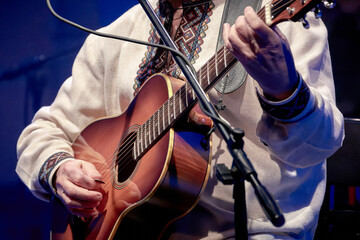 guitarist playing an acoustic guitar