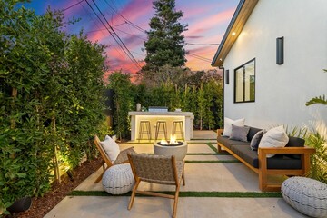 Modern outdoor patio with cozy seating and fire pit.