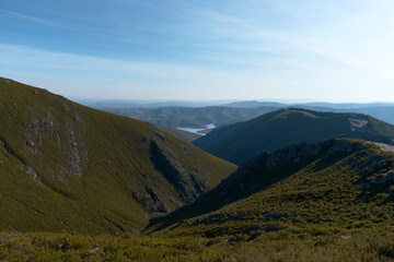 Fototapeta premium Scenic Valley with Distant River and Rolling Hills