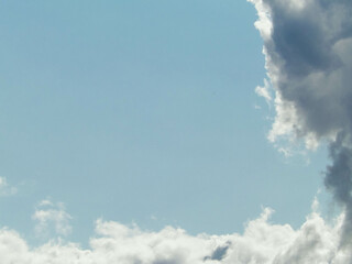 Clouds gathering on blue sky.