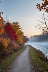 Naklejka premium Serene Autumn Path Along Misty River in Vibrant Colors.