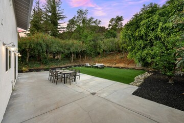 Modern backyard patio with outdoor dining set.