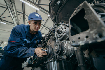 Auto mechanic repairs an engine. Replacing the timing chain