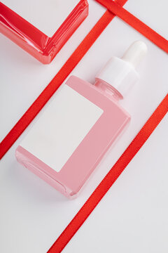 Elegant Cosmetic Package with Red Ribbon