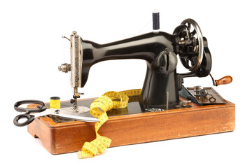 Sewing machine, measuring tape, scissors, safety pins and spools of threads isolated on white
