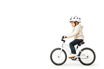 Fototapeta premium Side view little kid in helmet riding bicycle isolated on white background