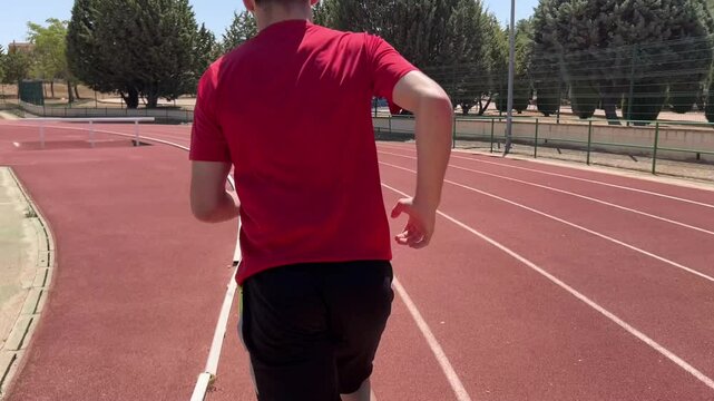 Male athlete training on a track during a sprinting dril