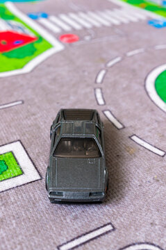 Mattel Hot Wheels DMC toy model car on a road mat