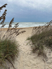 Path through sand dunes and waves on a stormy day, Outer Banks sand beach