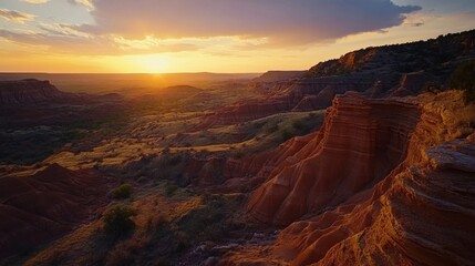 A breathtaking view of Palo Duro Canyon at sunset with vibrant colors illuminating the rocky formations and expansive landscape