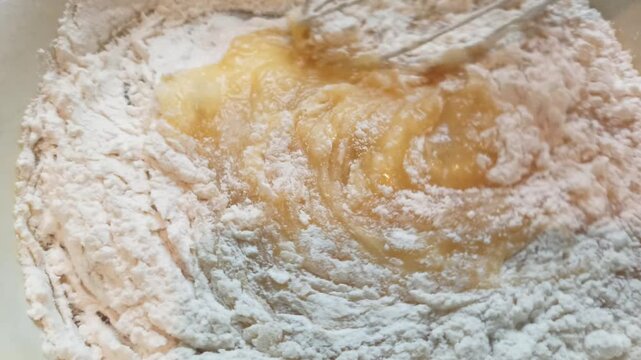  Proccess of making shortbread dough for a pie, mixing with whisk. Horizontal 4k footage. Baking