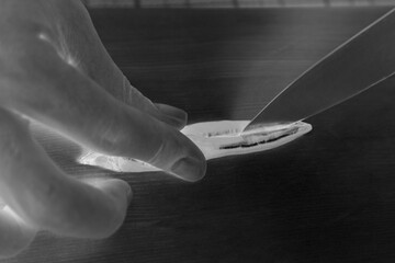 Person cutting a chilli pepper