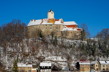 schoenfels castle in the snow, saxony east germany