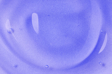 Purple gel fluid with bubbles, macro texture of cosmetics product. Cosmetic lavender background.