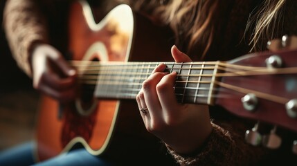 Fototapeta premium A close-up of a person learning to play the guitar, focusing on their hands as they practice finger placement on the strings