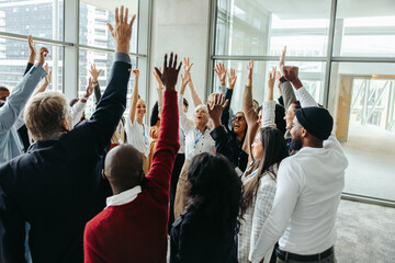 Successful team energizing at conference during a productive training day in a modern office...