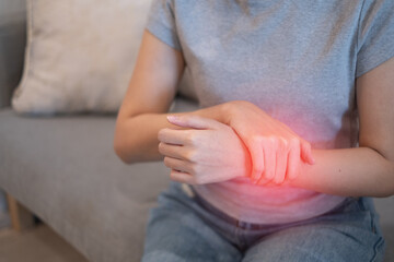 Woman female suffering from wrist sprain arthritis inflammation from physical injury problem