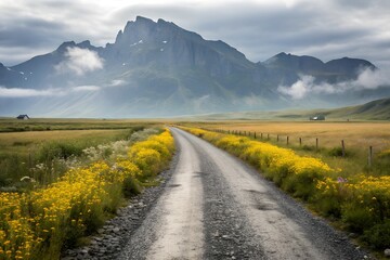 Naklejka premium Unveiling the Path Ahead A solitary gravel road winds through a field of golden wildflowers, leading towards a majestic mountain range shrouded in mist.