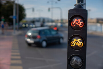 Budapest, Hungary - August 24, 2024: Yellow bike signal on a city road: a sign of caution.