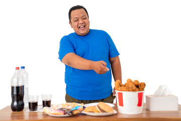 A happy man joyfully presents a delicious fast food spread with crispy chicken and drinks