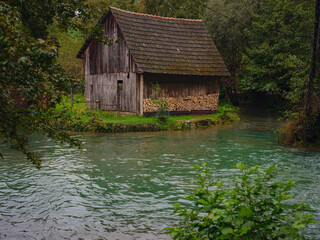 Charming details of Rastoke , Croatia, showcasing traditional wooden houses, stone mills, and vibrant green landscapes. The historic architecture and flowing streams create quaint, rustic ambiance.