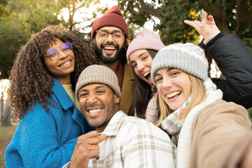 Selfie portrait of a big group of cheerful young friends happy smiling looking at camera. High quality photo