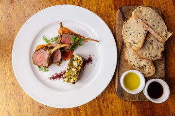 Delicious Gourmet Rack of Lamb With Artisan Bread and Sauces
