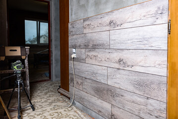 Obraz premium Installation of laminated panels on wall at room.