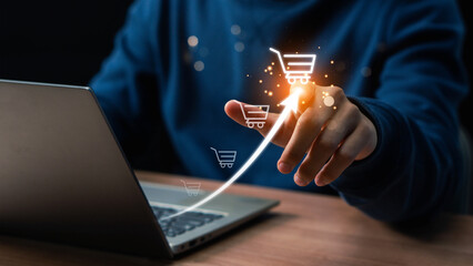 Businessman hand touching to virtual info graphics with trolley cart icons. Increase higher sale...