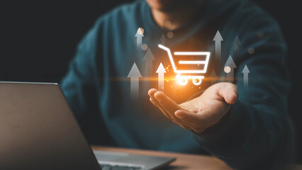 Businessman hand touching to virtual info graphics with trolley cart icons. Increase higher sale...