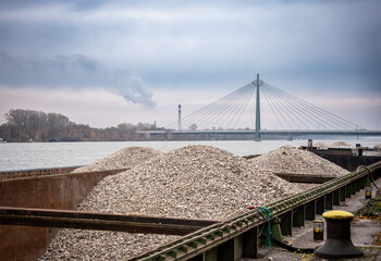 Industrial Landscape with Barge, Bridge, and Smoke Stack - River, Waterway, Cargo, Transportation, Logistics, Industry, Factory, Pollution, Environment, Climate Change, Urban, Cityscape, Bridge, Const
