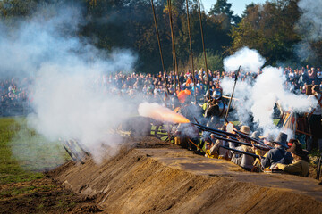 Fire coming out historic muskets fired during a cosplay battle from the Eighty Years War of the Dutch Republic against the King of Spain.