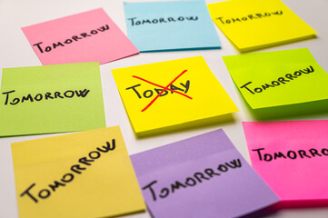 Colored card, with the word Today, crossed out, and next to it cards with the word Tomorrow. Procrastination and postponement.