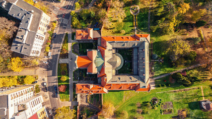 Drone view of ancient, famous landmarks in Krakow, Poland. Picturesque landscape of autumn bushes and trees.
