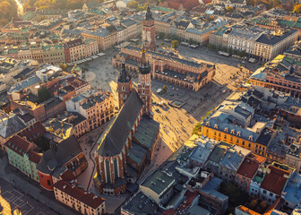 Fototapeta premium Krakow's central square from drone in sunset light. Main Market Square with Town Hall, Cloth Hall and St. Mary's Basilica.