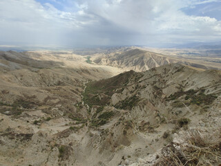 View of landcape with mountains and hills. Beautiful clouds above mountains. Vivid natural scenery...