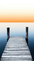 Fototapeta premium A serene wooden dock extends into a calm lake, reflecting beautiful hues of orange and blue during sunset, offering tranquility.