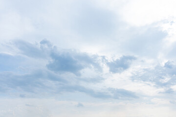 Obraz premium Fluffy white clouds drift across a bright blue summer sky