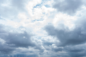 Obraz premium Fluffy white clouds drift across a vibrant blue summer sky