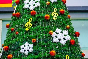 Christmas tree with New Year's toys balls, glowing snowflakes music theme