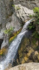 Obraz premium A gorge between cliffs, a waterfall, nature.