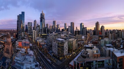 Fototapeta premium Panoramic city skyline at sunset, showcasing skyscrapers, buildings, streets, and transportation.