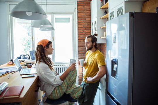 Young student couple studying together in the kitchen