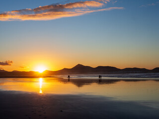 Stunning Orange Sunset Over Magical Beach with Volcanic Mountain Range, Lanzarote, Canary Islands