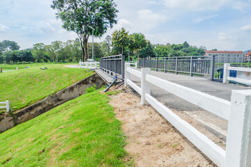 Fototapeta premium Street road near seaside or lake in morning,rest and relax in park near city,Nature landscape,countryside landscape,Transportation,highway near the forest lake,space for text..