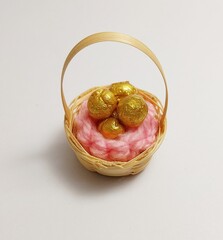 miniature cute handmade clay isolated sculpture gold egg bamboo basket cloth 
