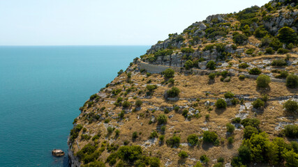 Aerial view of Saraceno Mount. It is a cliff on mediterranean Sea with a trekking path for mountain hiking.